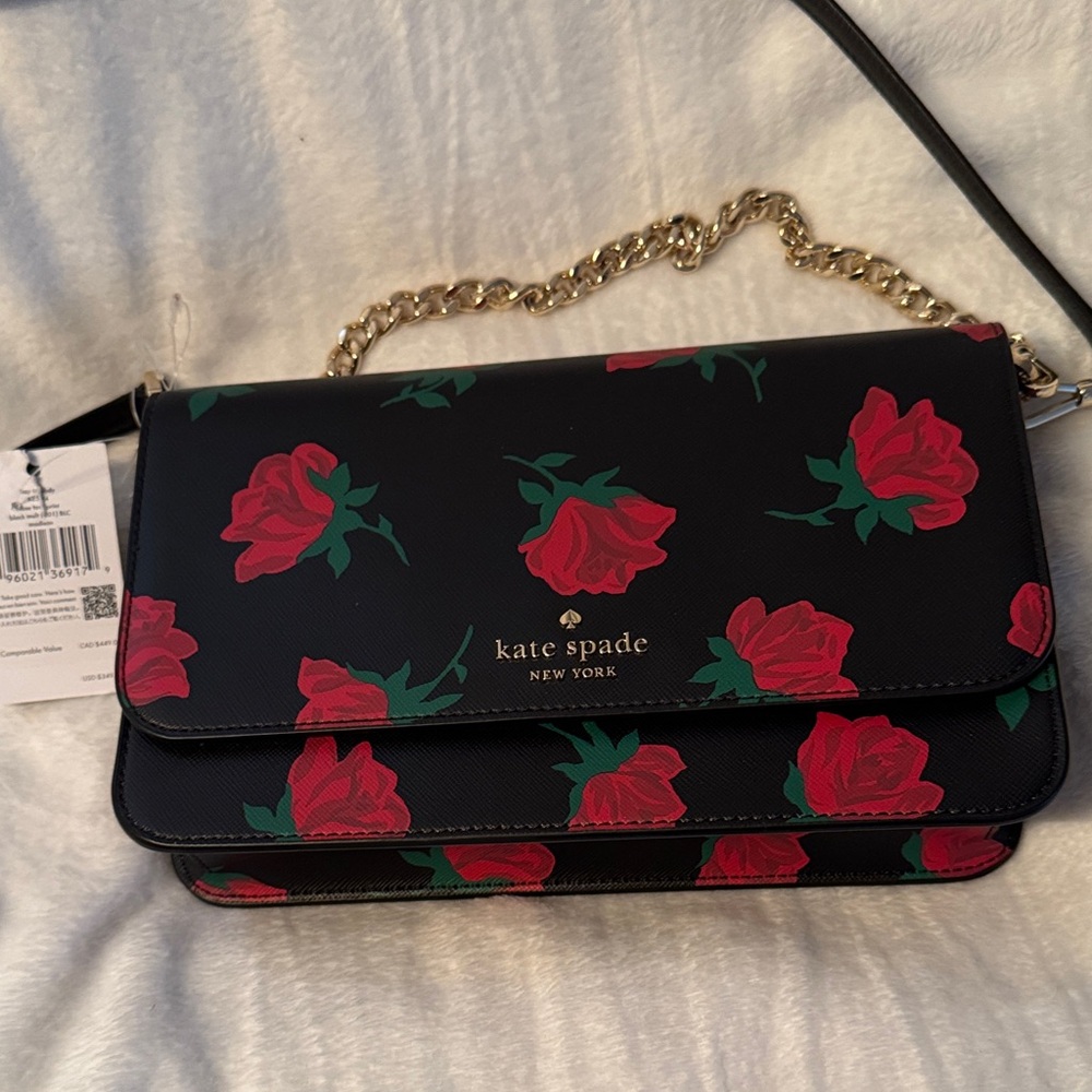 Kate Spade crossbody purse with rose pattern throughout.